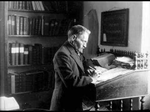 man writing at desk