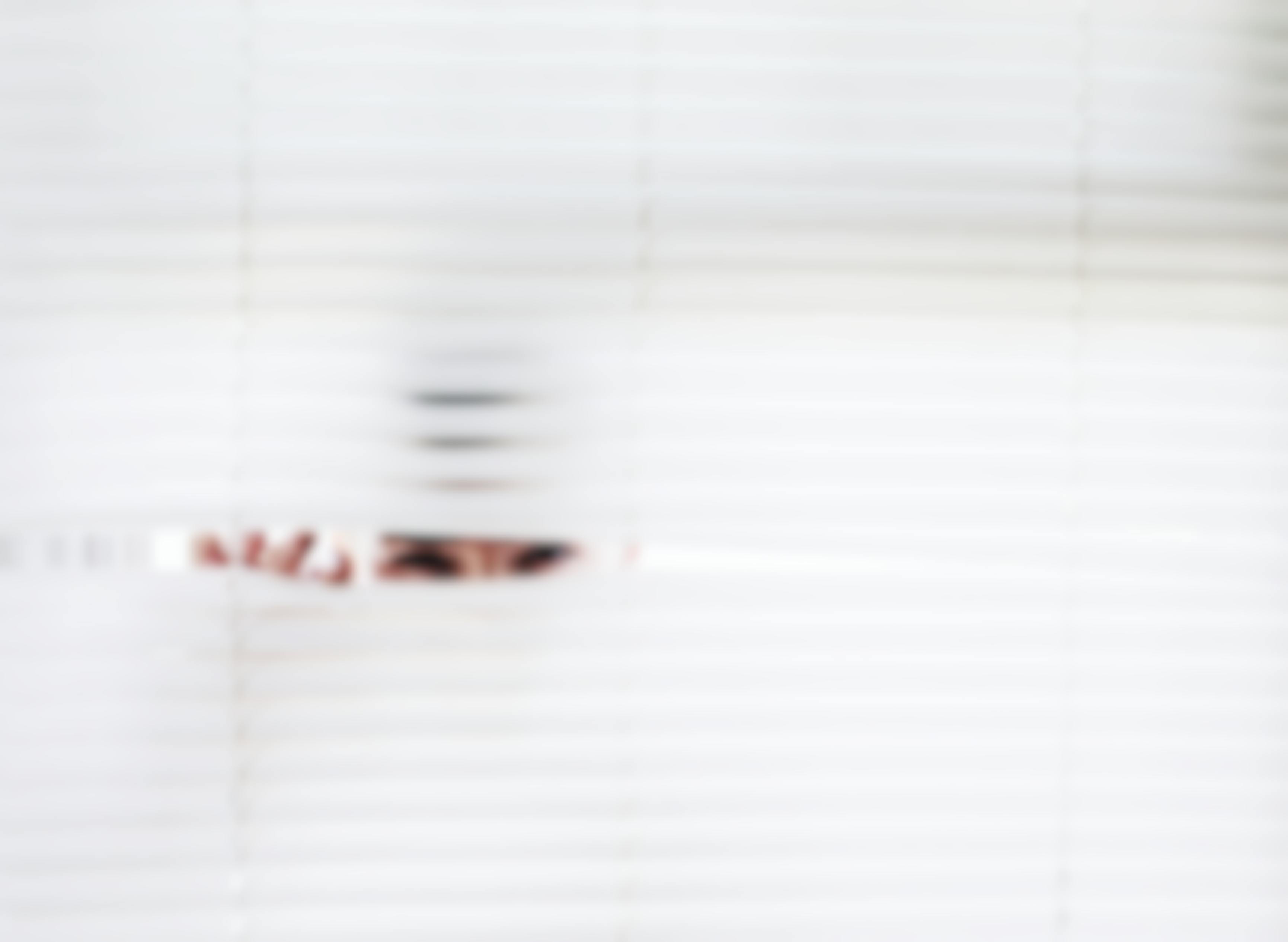 woman peeking out of blinds