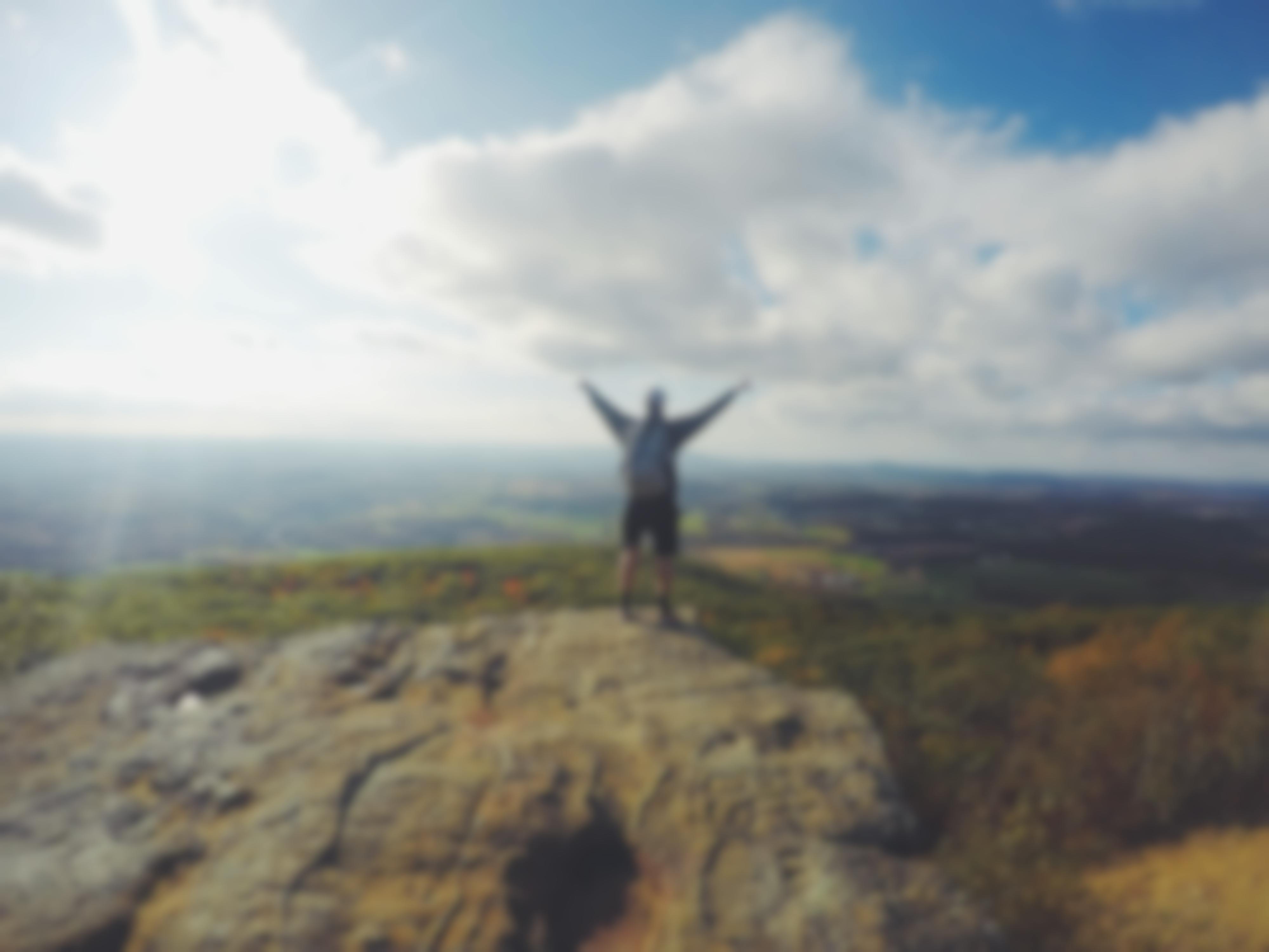 man on top of mountain