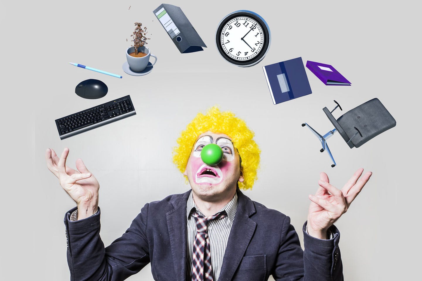 clown juggling office supplies