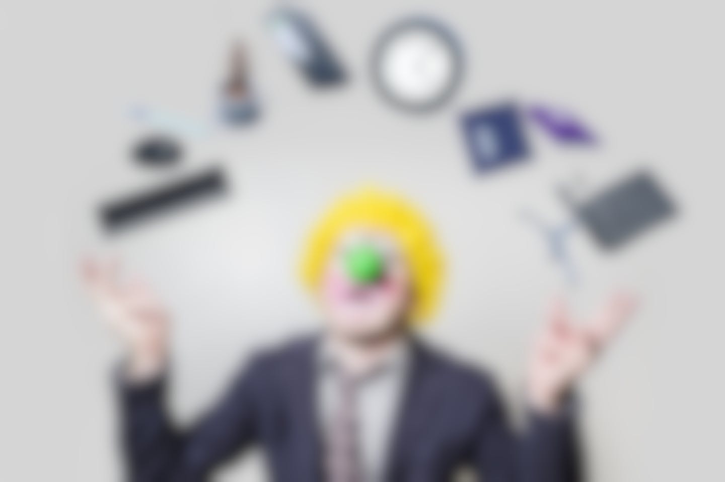 clown juggling office supplies