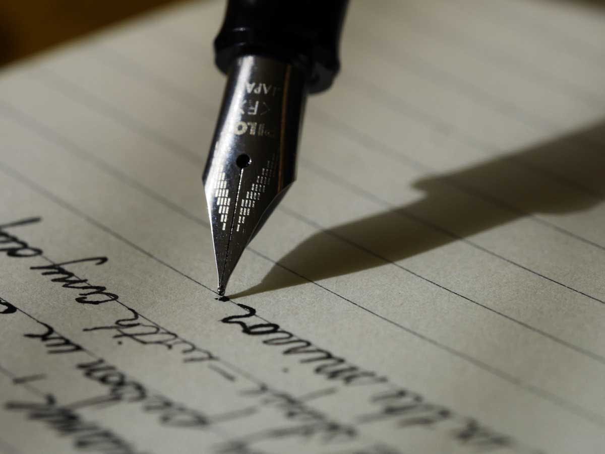 a closeup shot of a fountain pen on paper