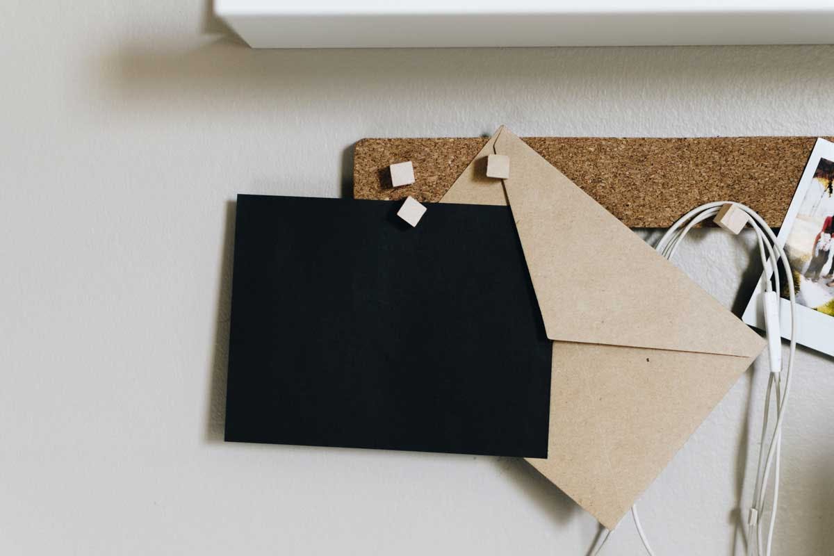 a letter being saved on a corkboard