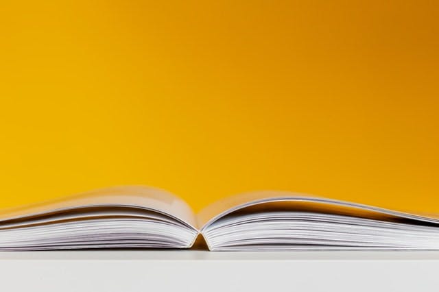 open book against yellow background