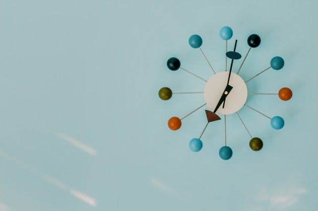 mid-century modern clock on blue wall