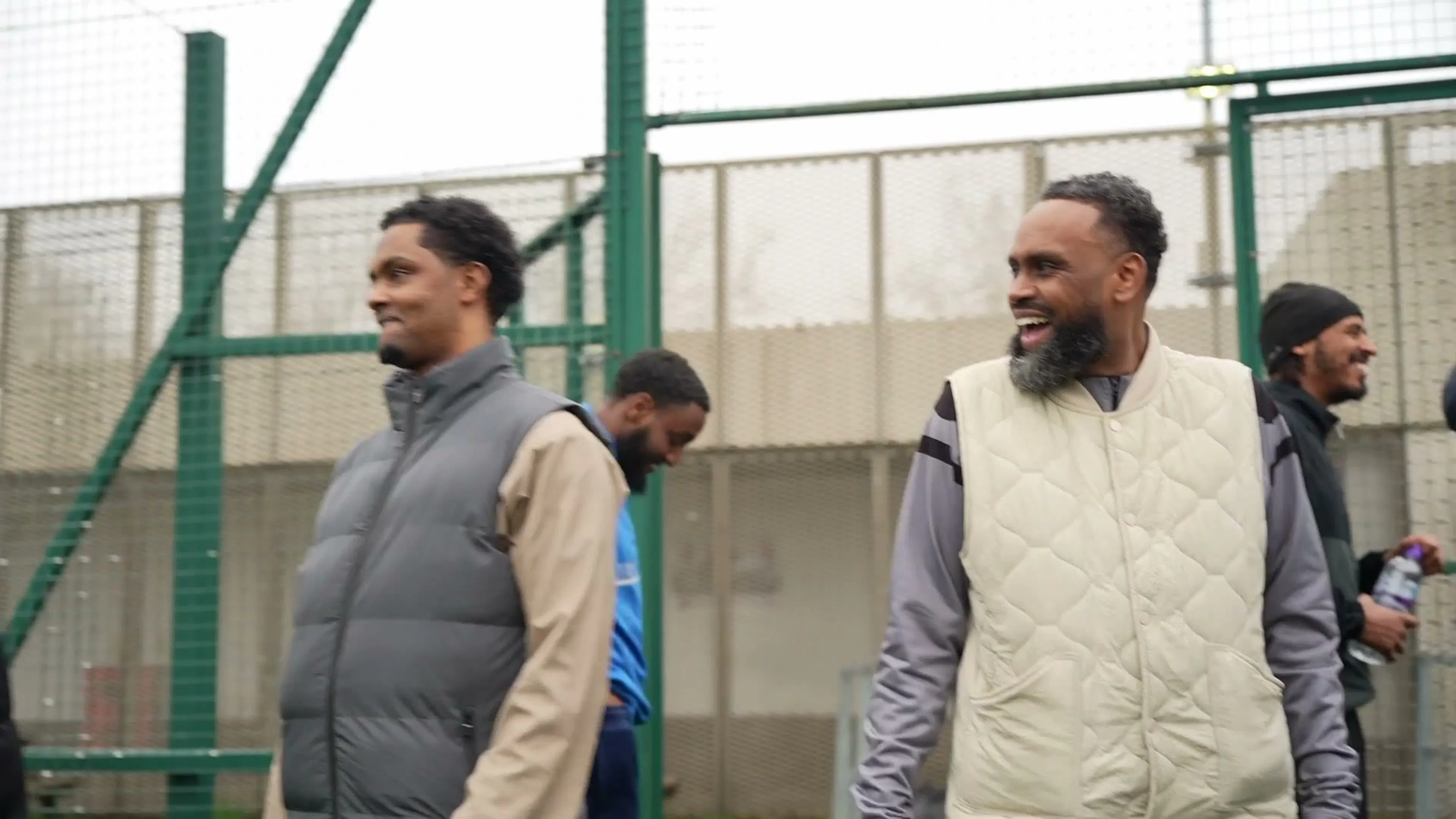 Two men laughing on the touchline at the Onside tournament