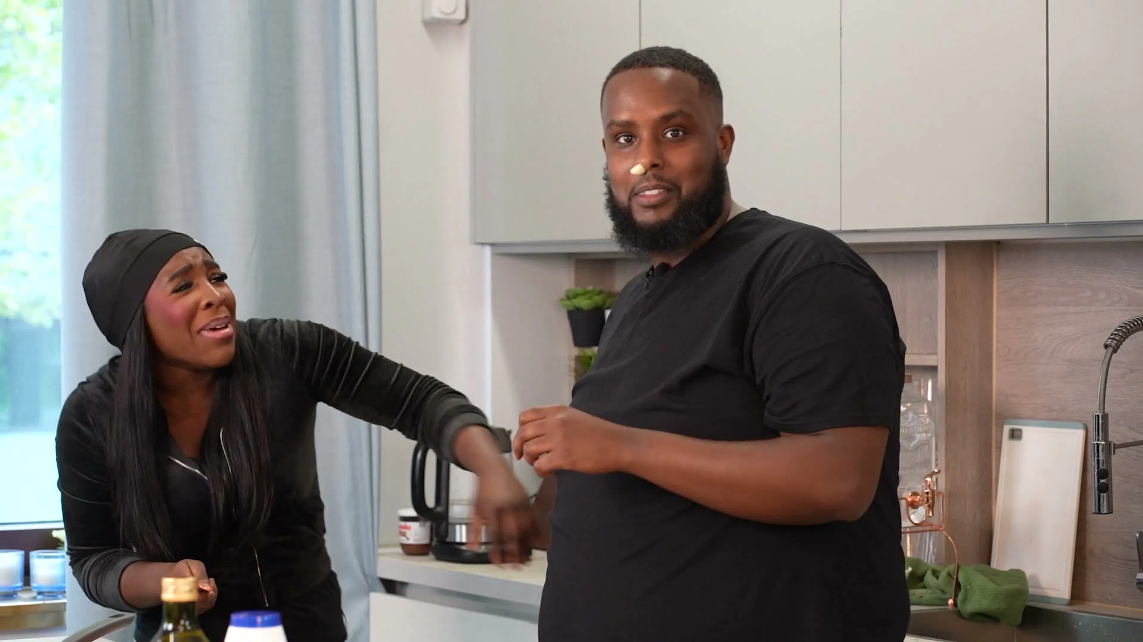 A guest and a host cooking side by side on Behind The Stove