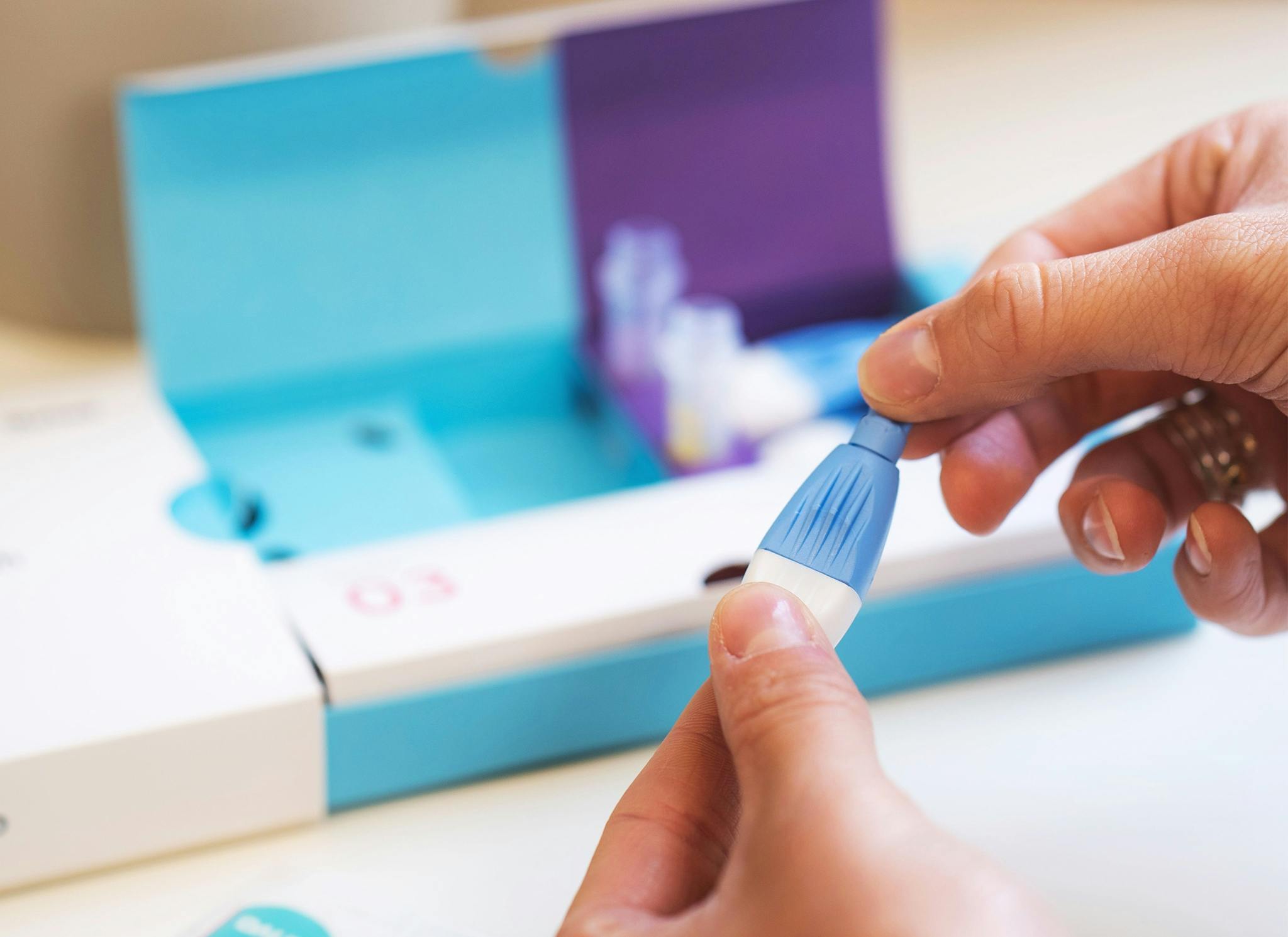 Thriva's blood testing kit — lancet to prick finger
