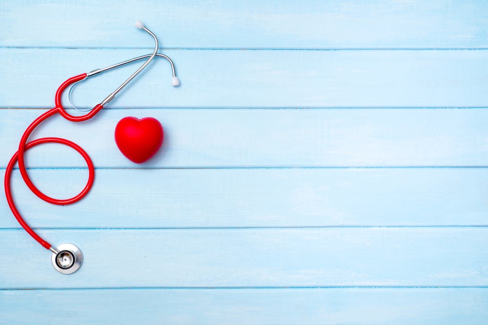 Cholesterol — stethoscope and heart on blue background