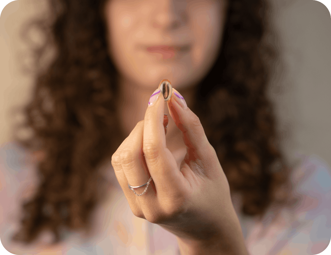 Woman holding Thriva's omega-3 supplement in her hand