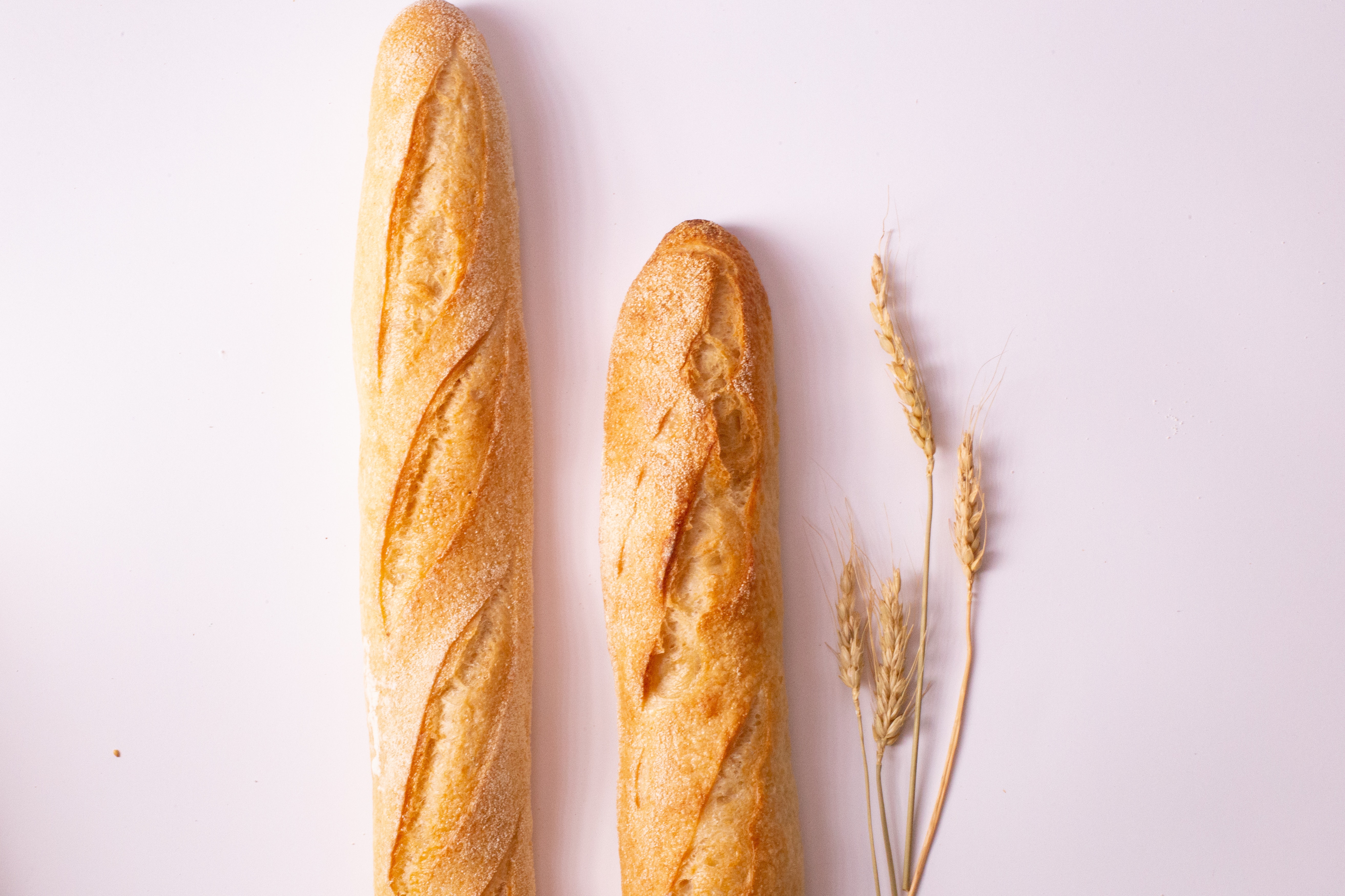 French baguette on pink background