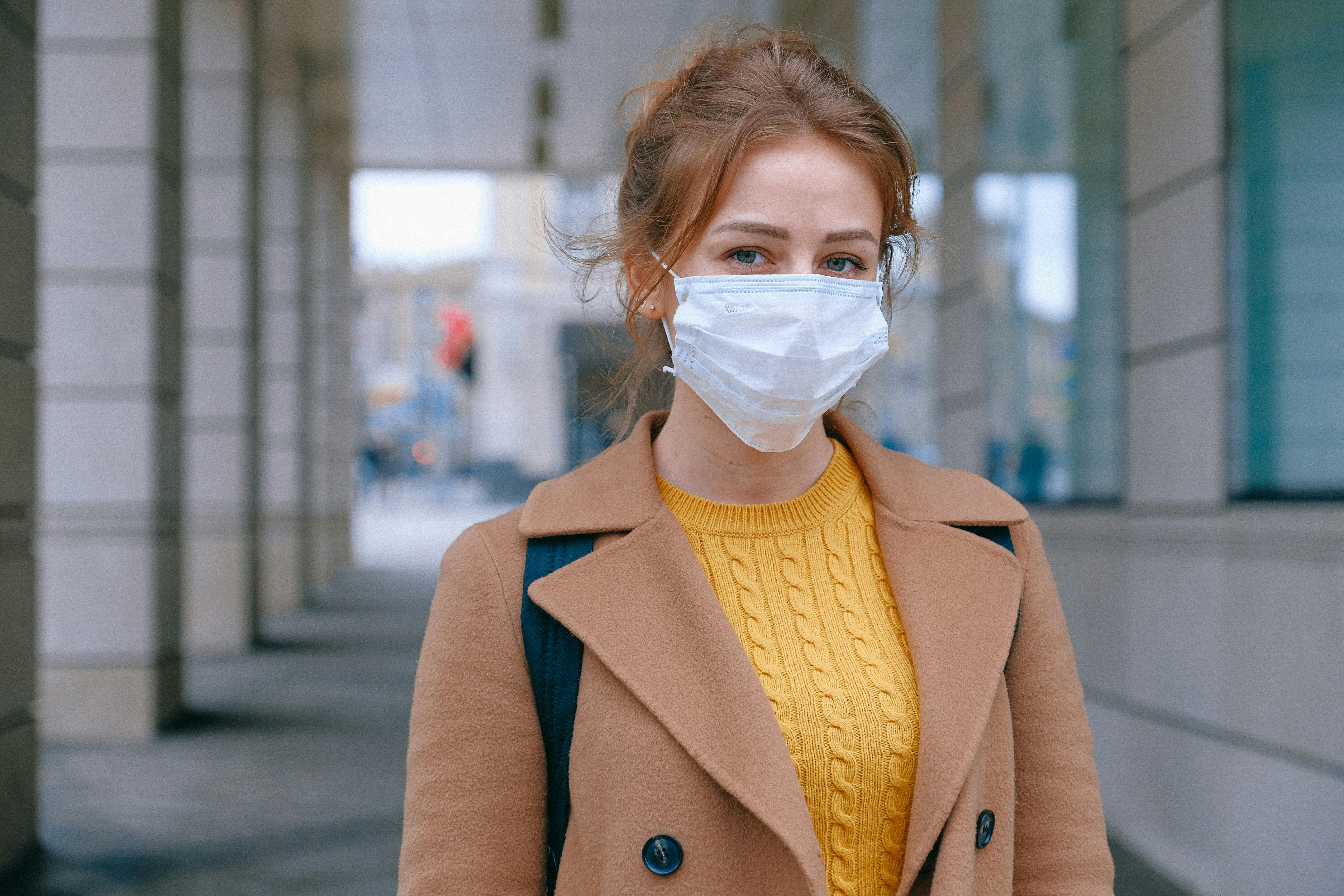 Woman wearing medical face mask to protect against COVID-19