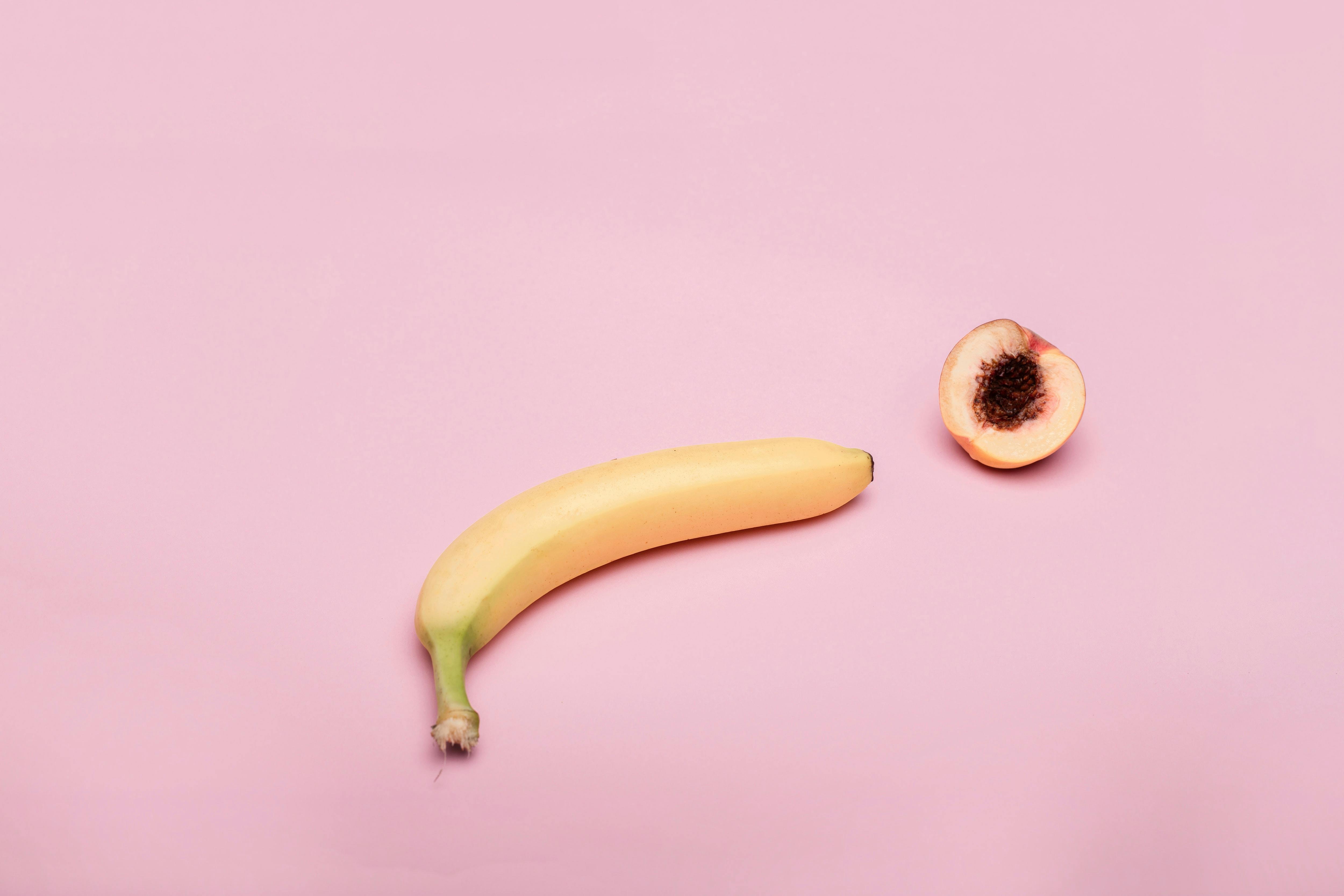 Testosterone and libido — banana and peach on pink background