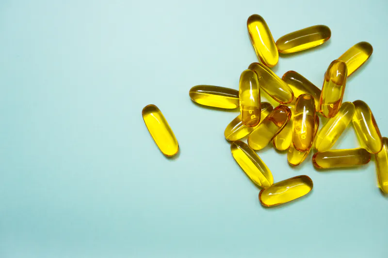 Omega-3 supplements on blue background