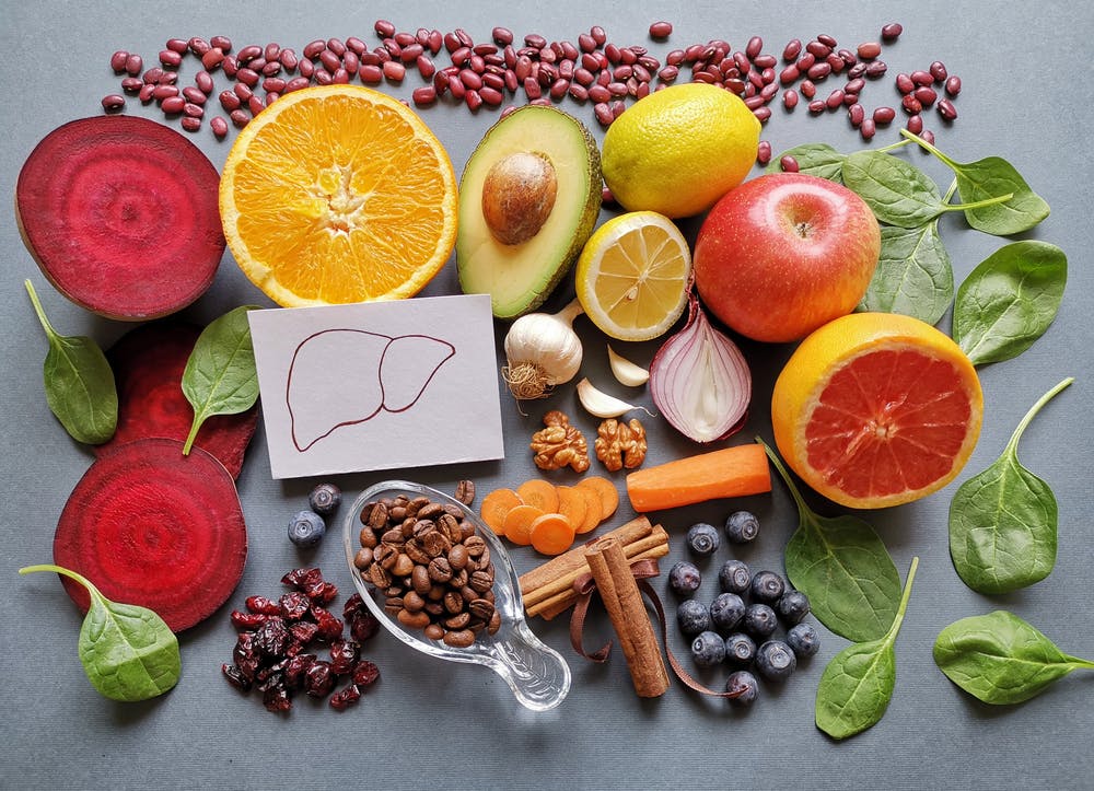 Human liver sketch surrounded by fruit and vegetables