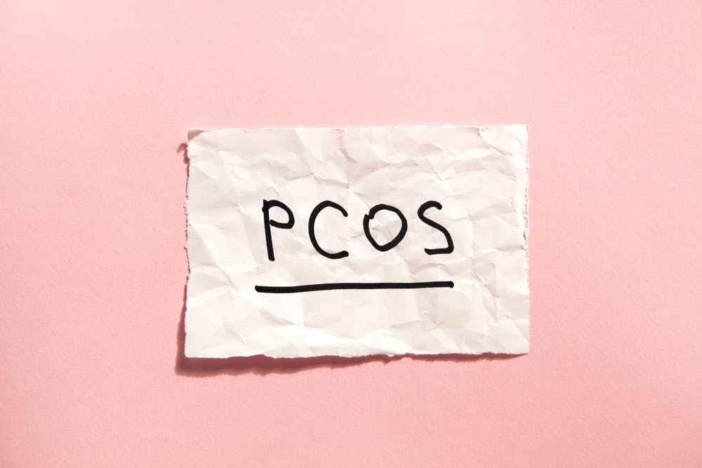 PCOS scribble on piece of paper on pink background