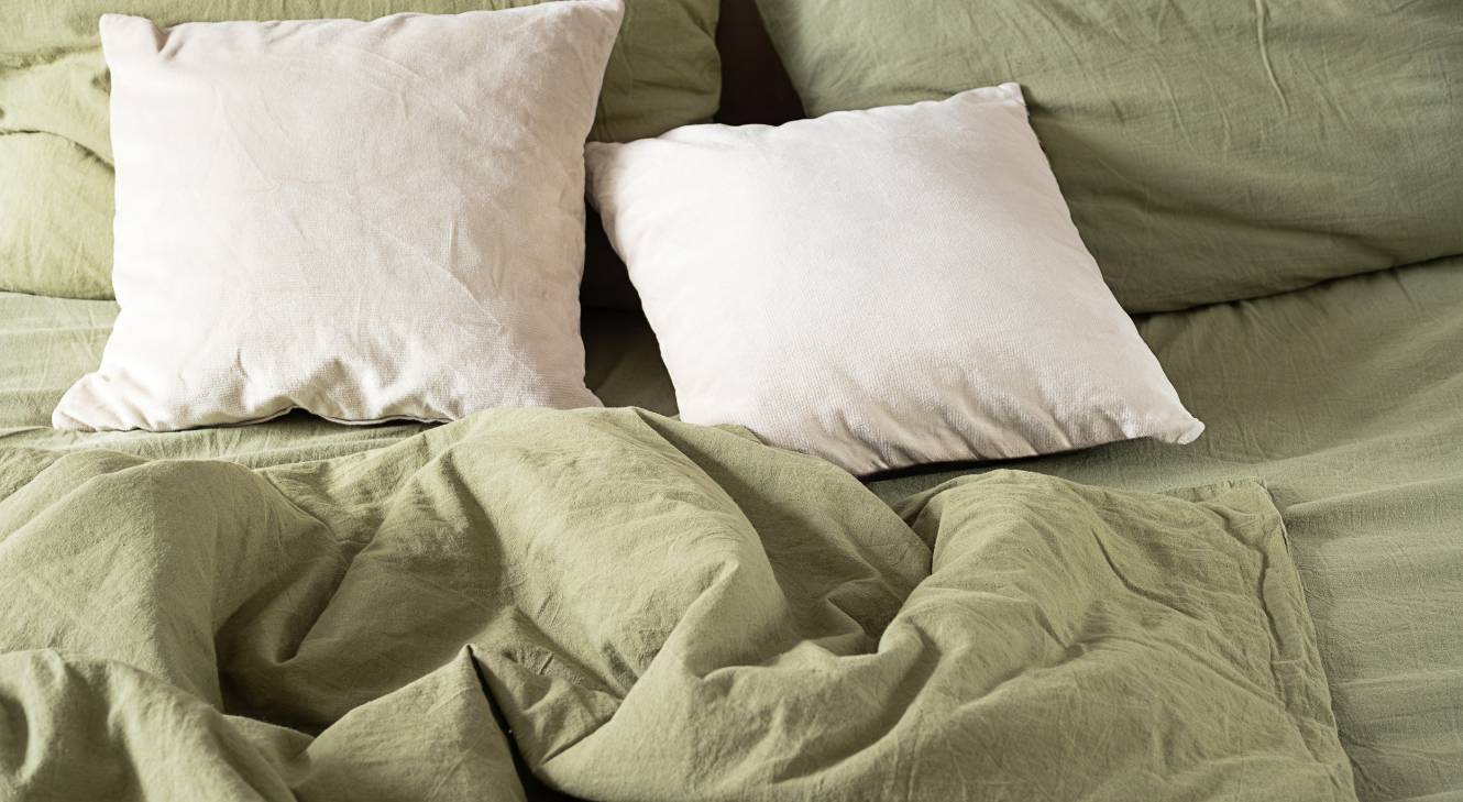 A bed with rumpled sheets. 