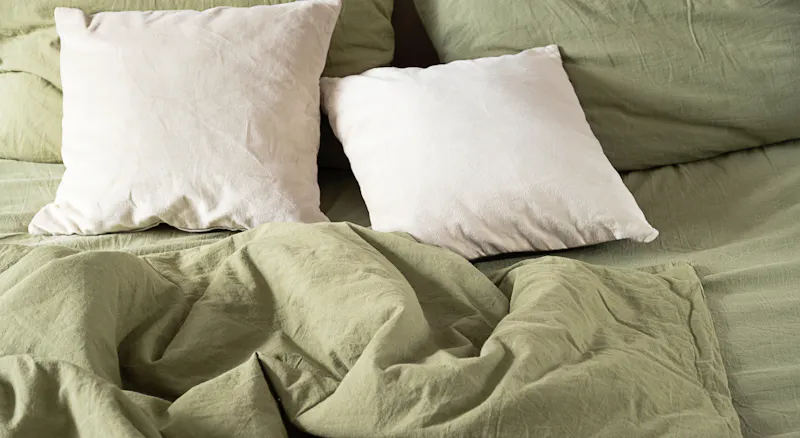 A bed with rumpled sheets.
