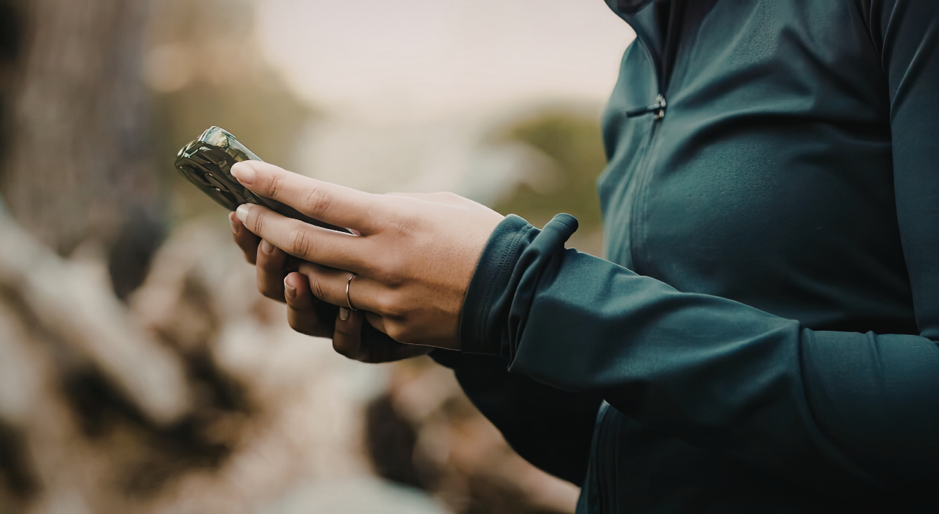 A person using a smartphone outside. 