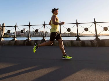 A man running next to a river