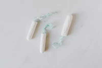 Three tampons on white background
