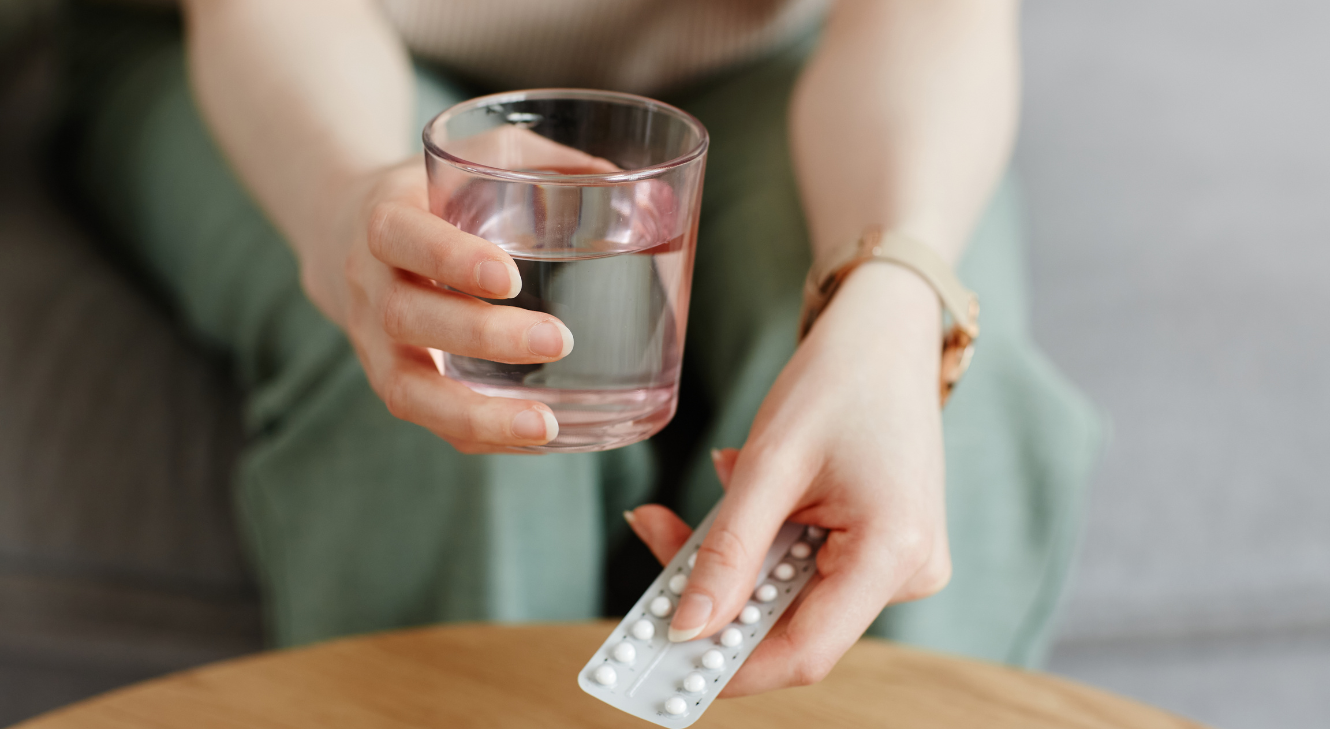 Woman holding a pack of birth control pills.