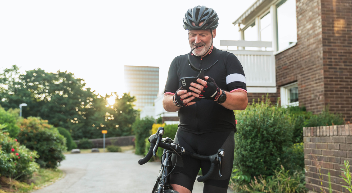 A man tracking data on his phone after cycling.
