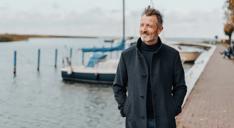 A man walking along the shore.