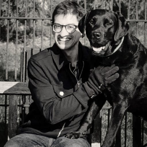An image of Dr Lucas Denton with his dog