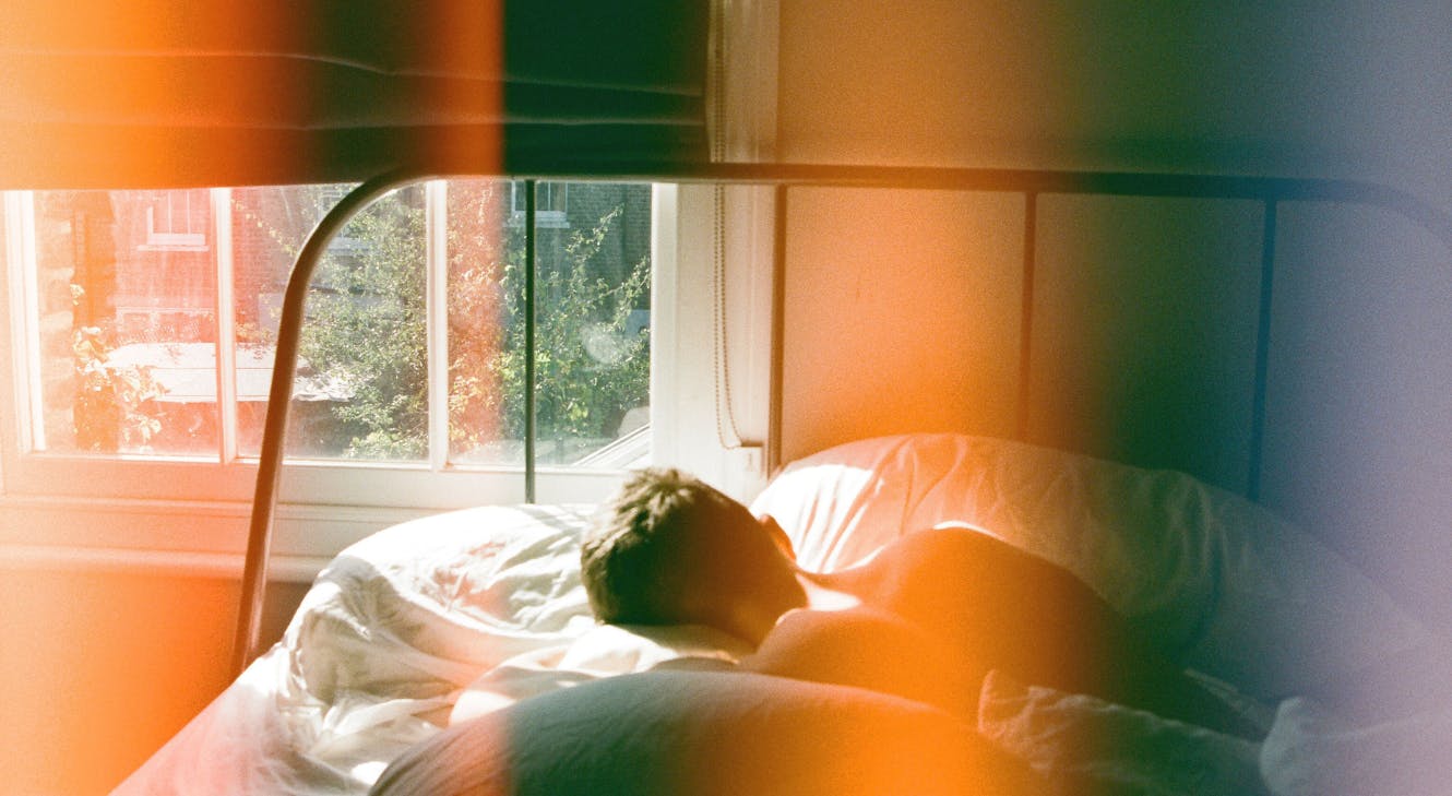 A person lying in their bed.