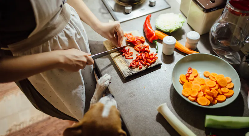 A woman chopping vegetables.