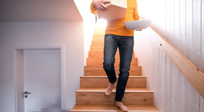 A man walking down the stairs.