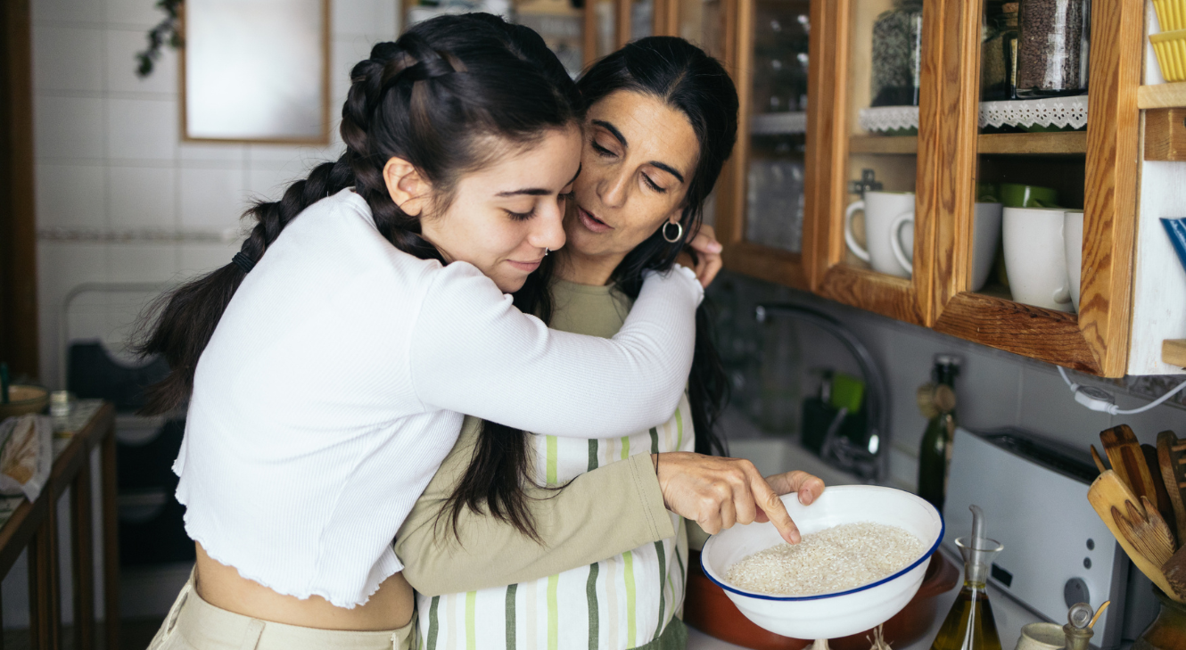A daughter hugging her mother.