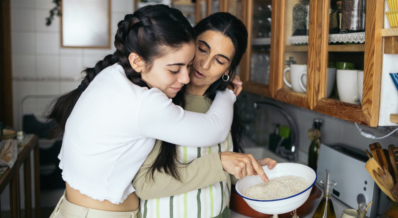 A daughter hugging her mother.