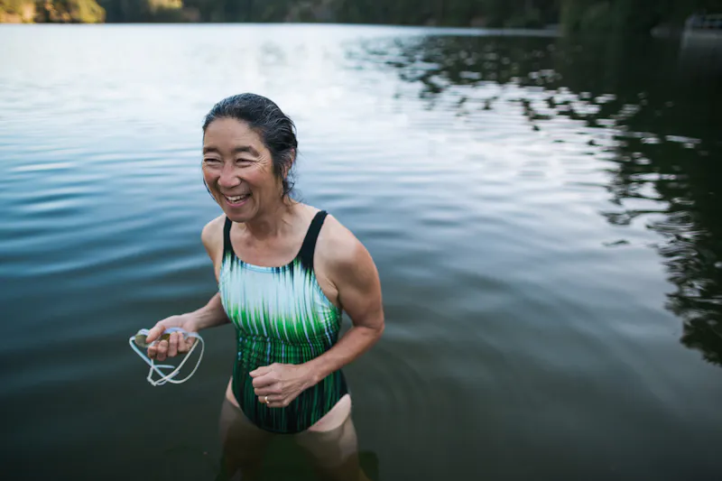 A woman swimming outdoors.