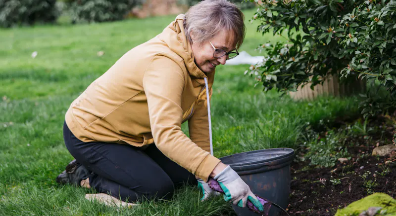 A woman gardening outdoors.