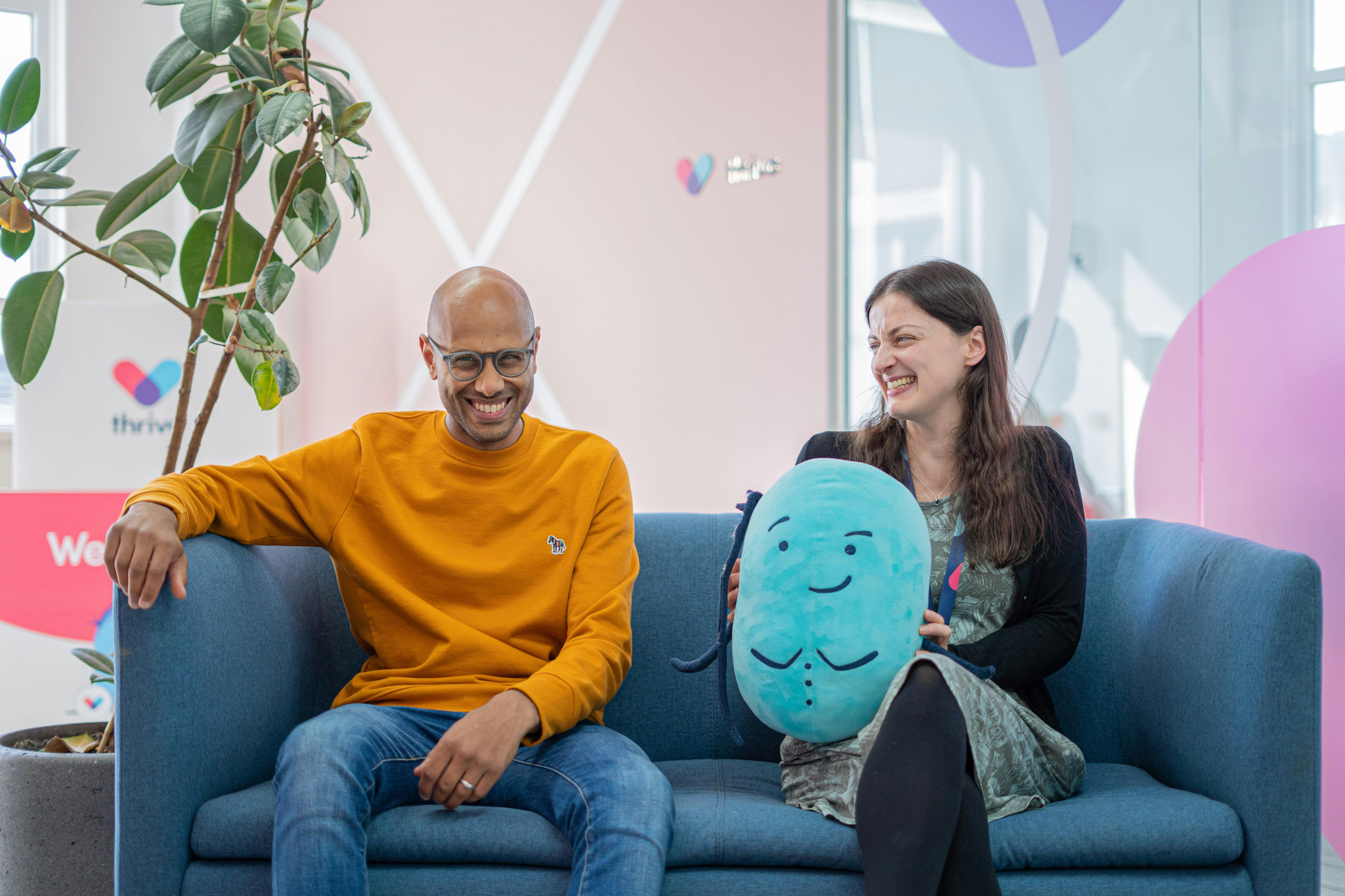 Dr Vishal Shah and Dr Jenny Williams sat on blue sofa at Thriva HQ