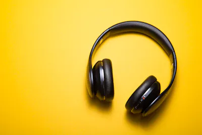 Black headphones on yellow background