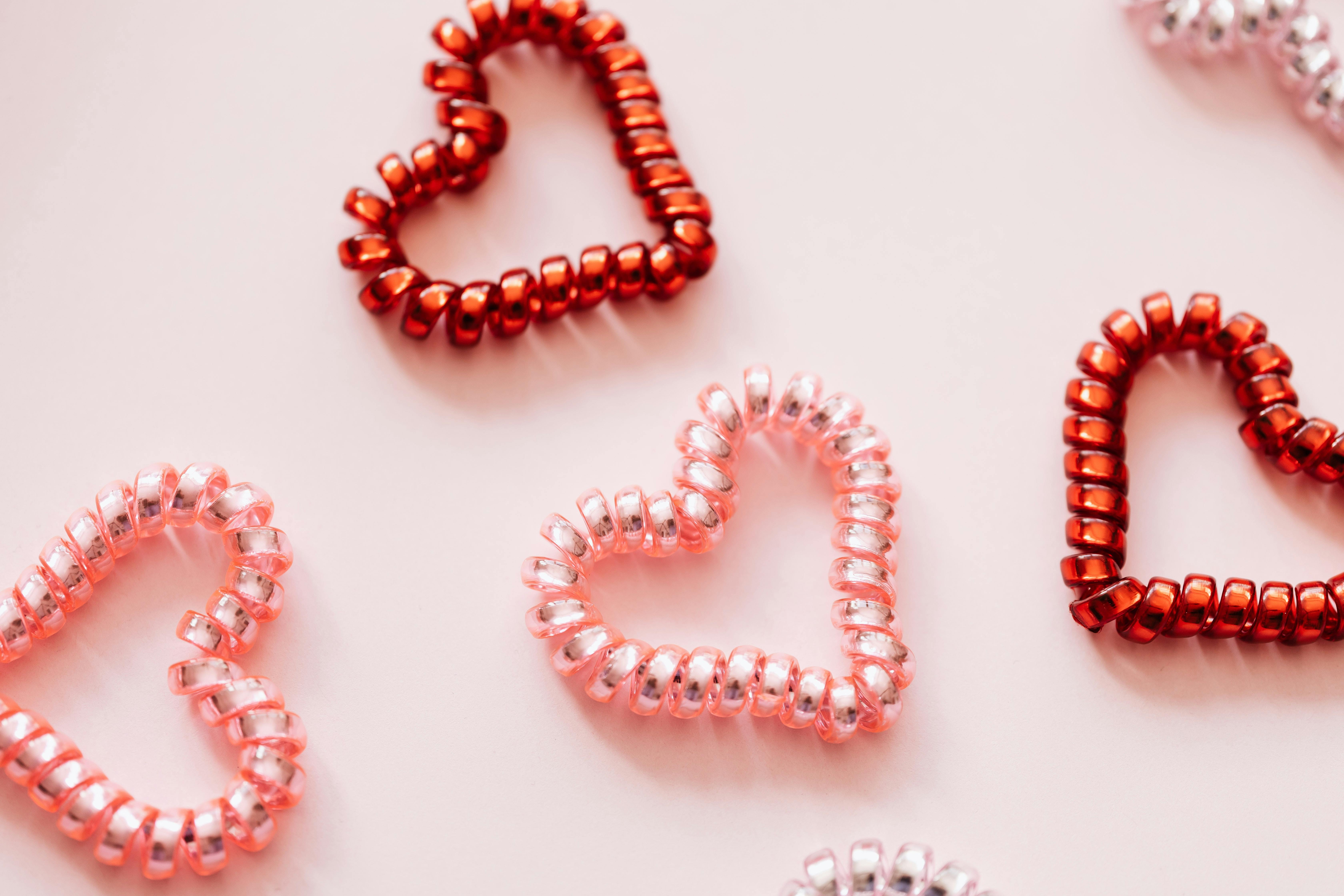 Red and pink hearts made from coiled plastic