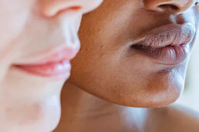 Nose and lips of two people with fair and mid skin tones