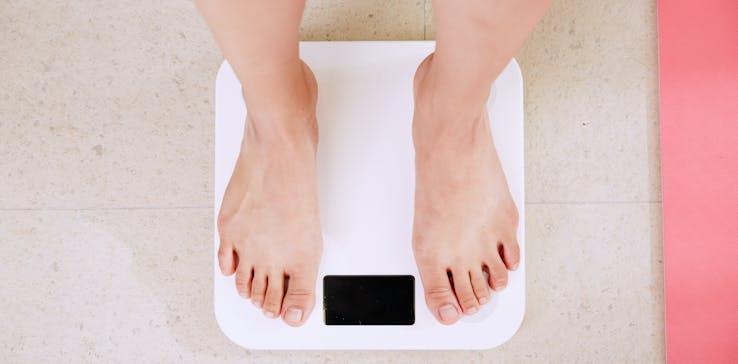 Woman stood on weighing scales