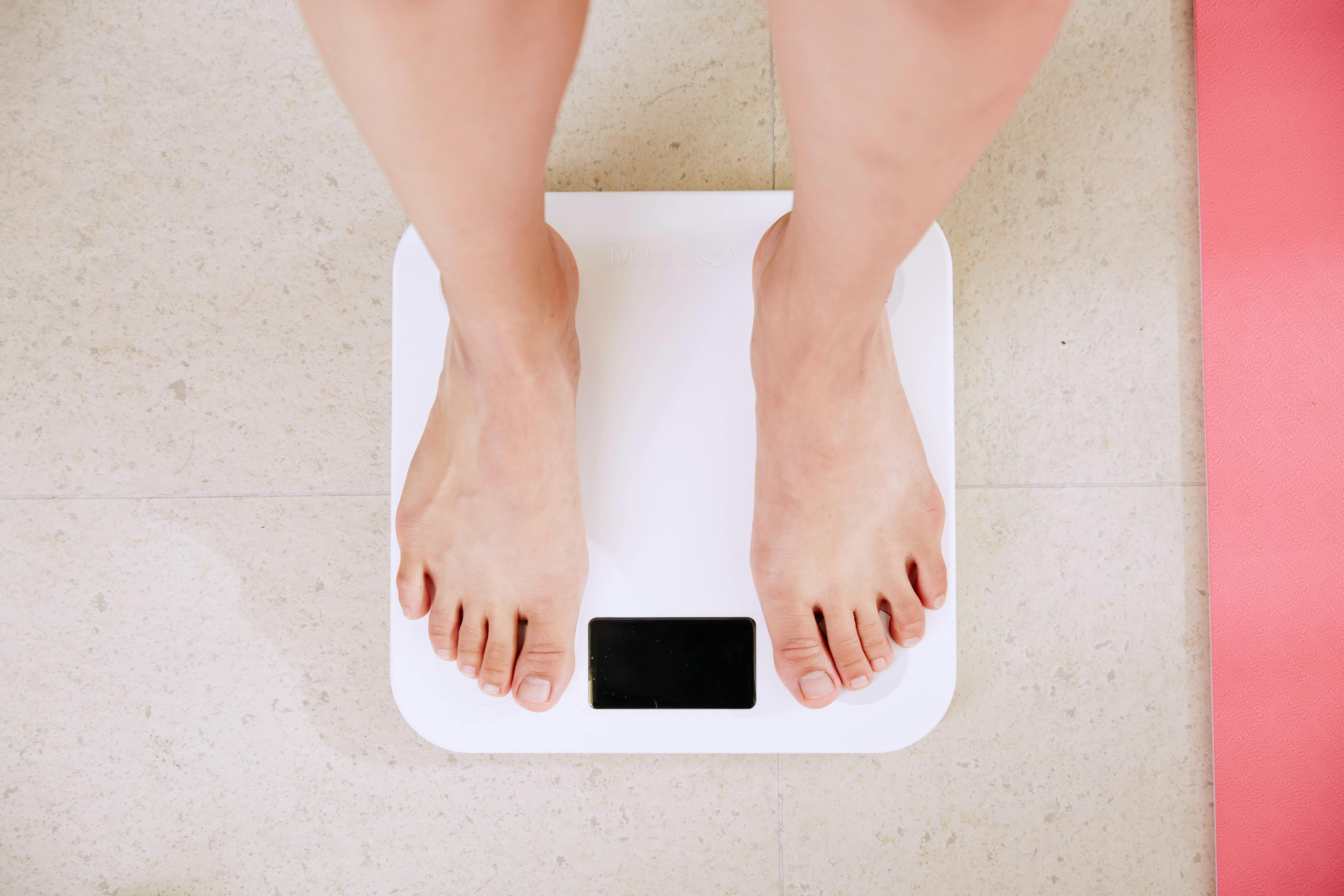 Feet standing on weighing scales
