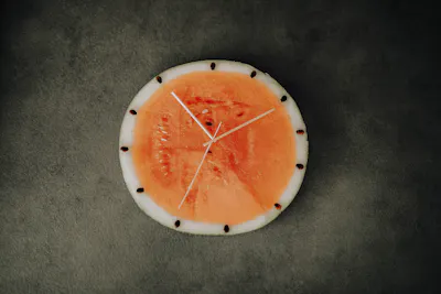 Clock made from watermelon and wooden sticks