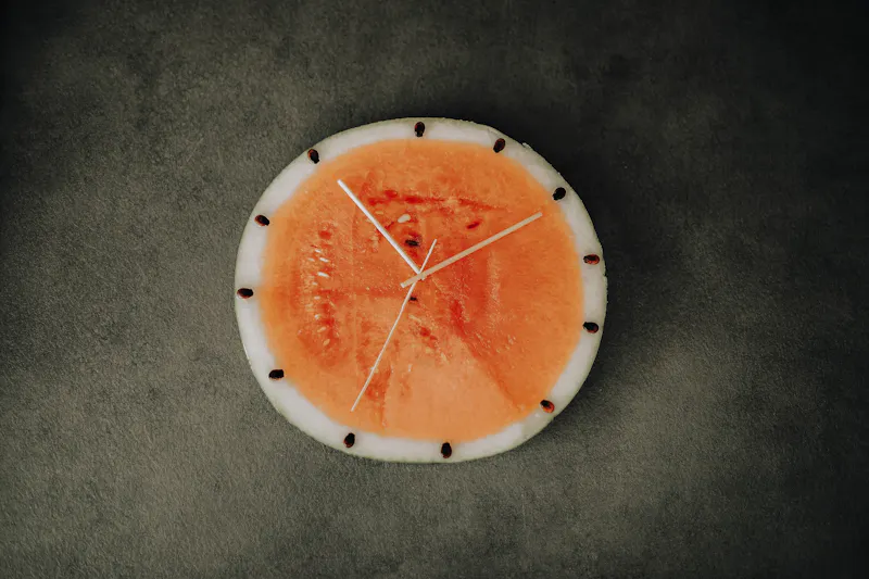 Clock made from watermelon and wooden sticks