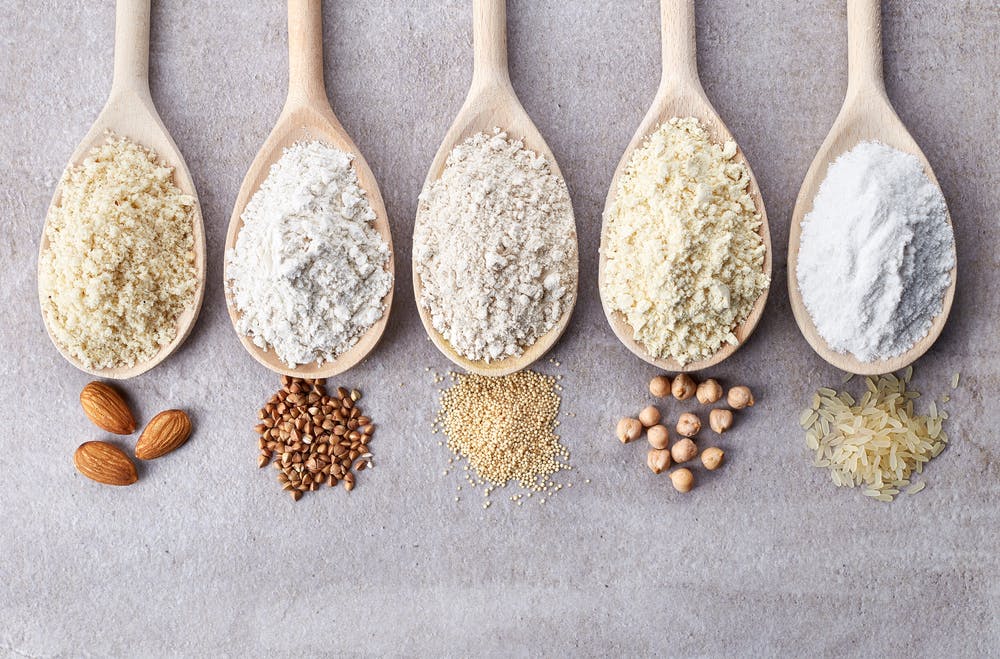 Gluten-free flours on wooden spoons