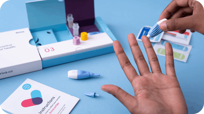 Thriva test kit and person taking finger prick sample using lancet