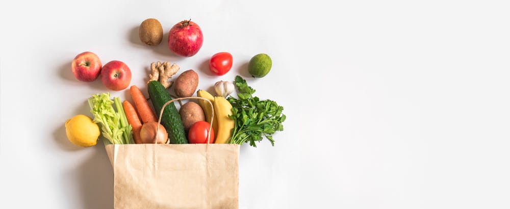 Fruits and vegetables in brown paper bag