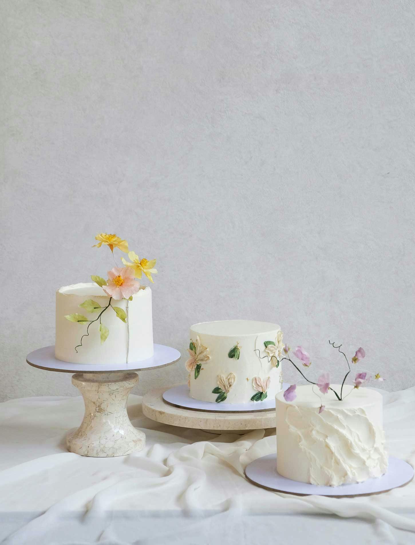 Different celebration cake designs set against a grey-white background