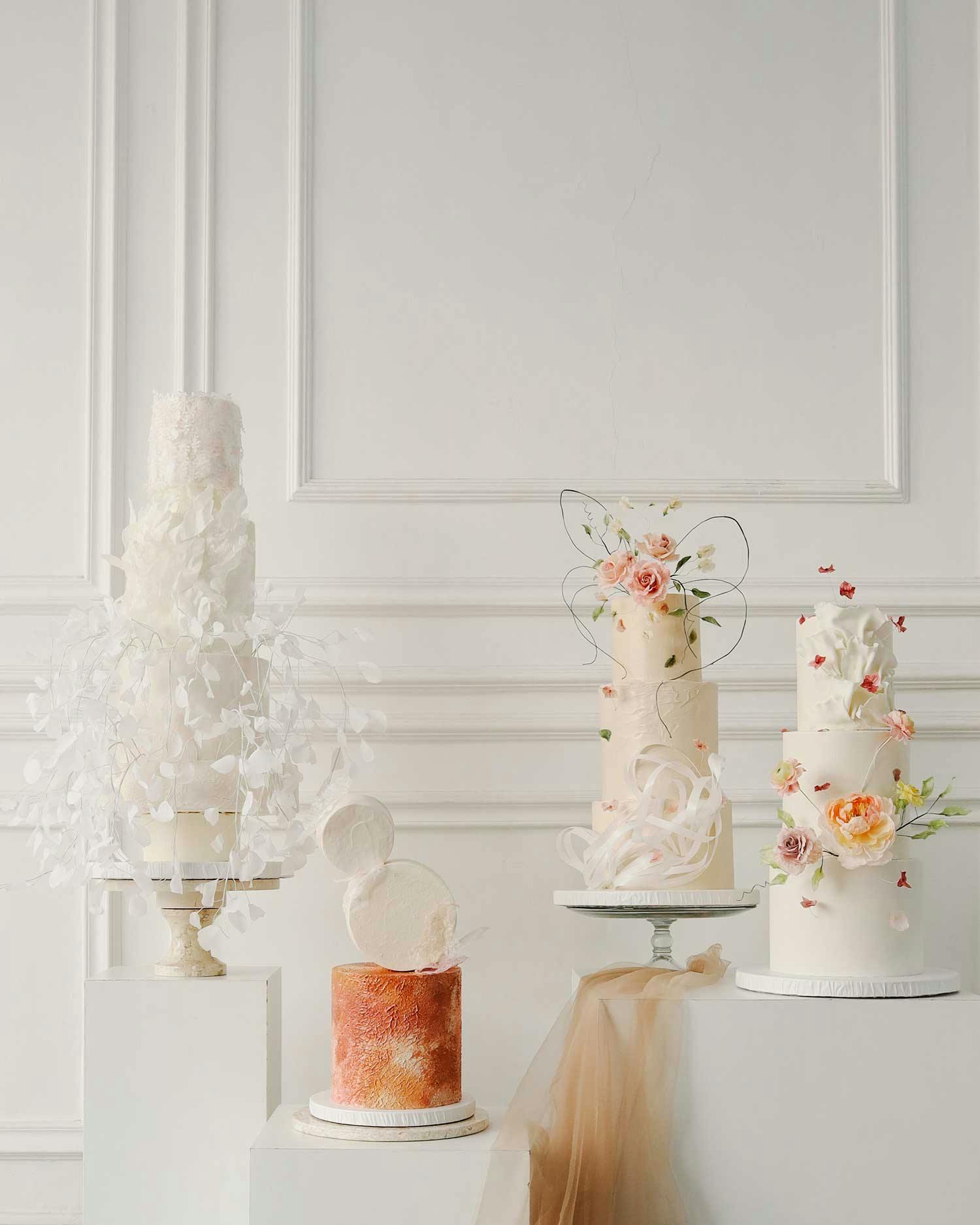 Different wedding cake designs set against a white background