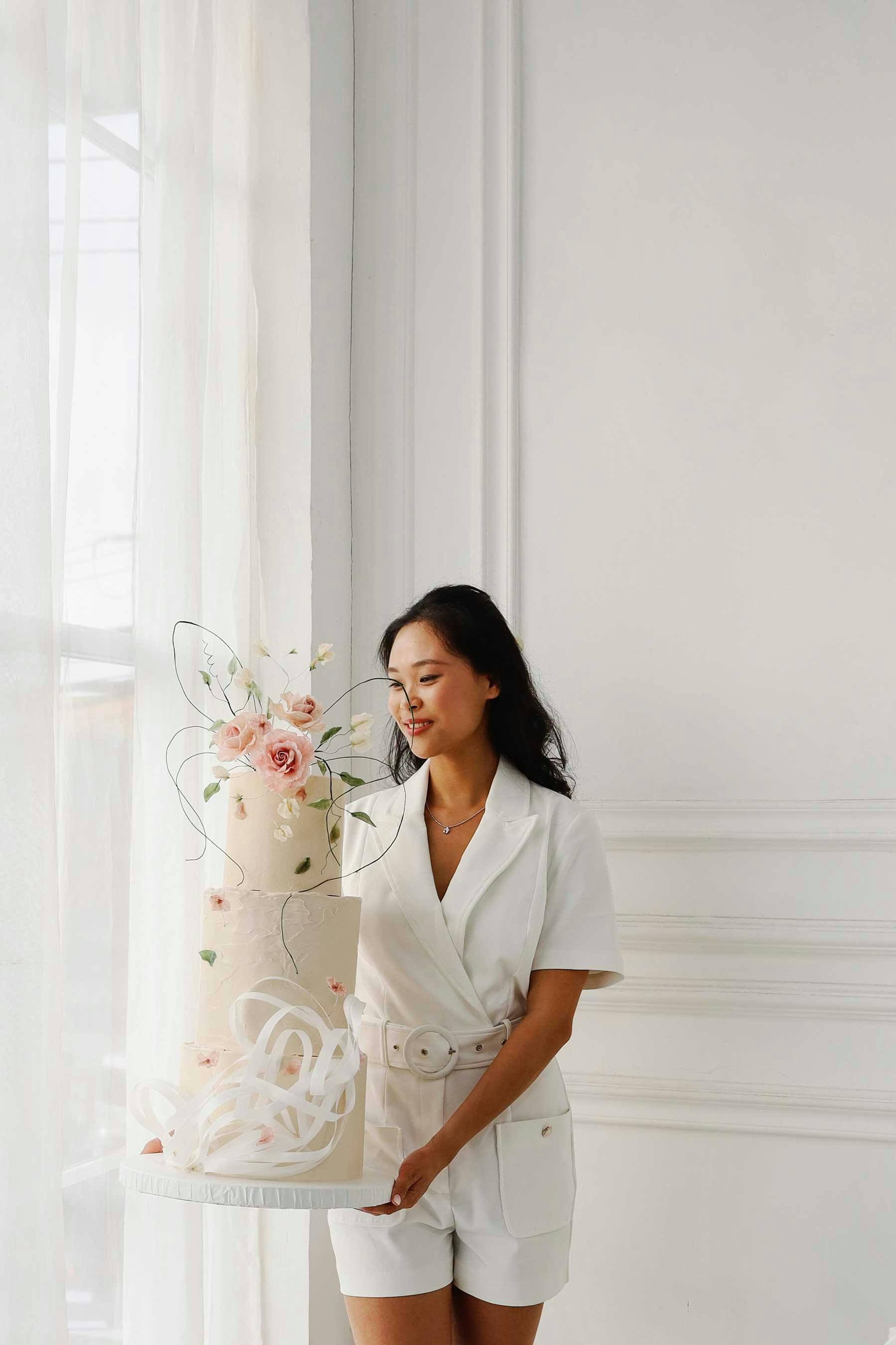 Arielle, our founder holding one of her creations - a beautifully curated wedding cake